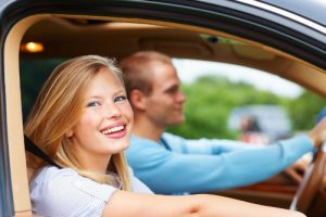 happy couple driving with windows open