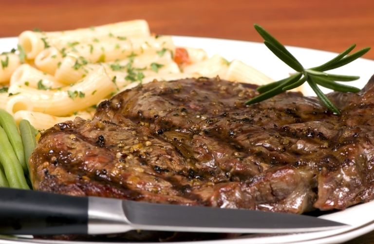 Steak and pasta served together