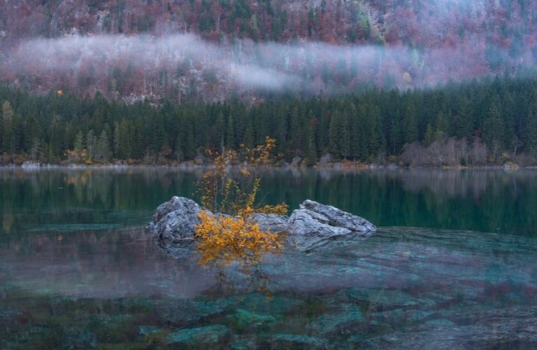 A rock in the middle of a lake