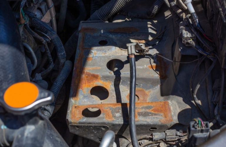 A corroded battery case caused by excessive exposure and acid attack