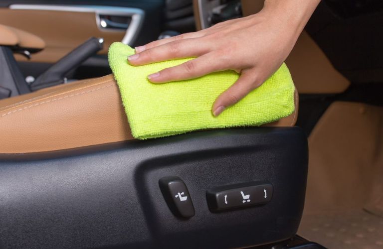 Close up of a hand cleaning a car
