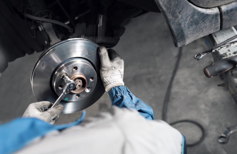 Close of image of a hand fixing the brake of a car.