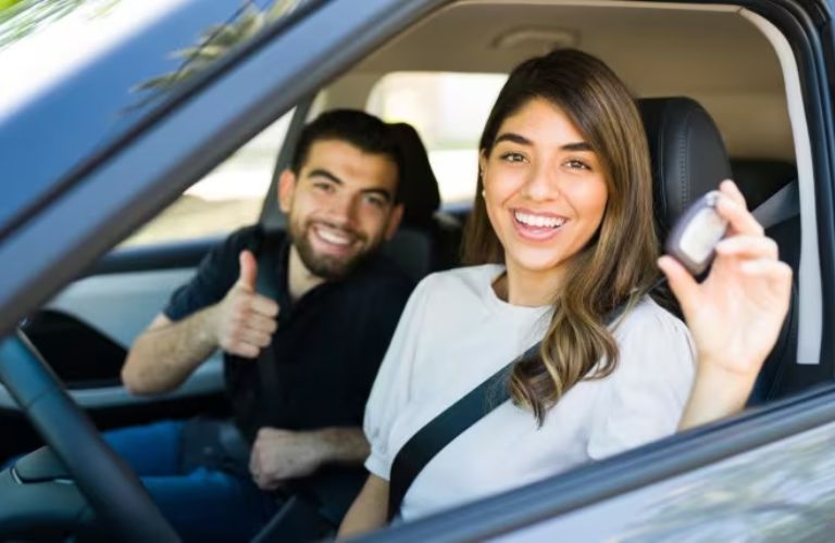 A couple inside a newly purchased car