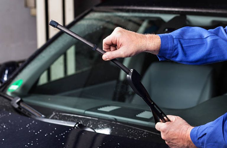 Mechanic showing a car's windshield wipers