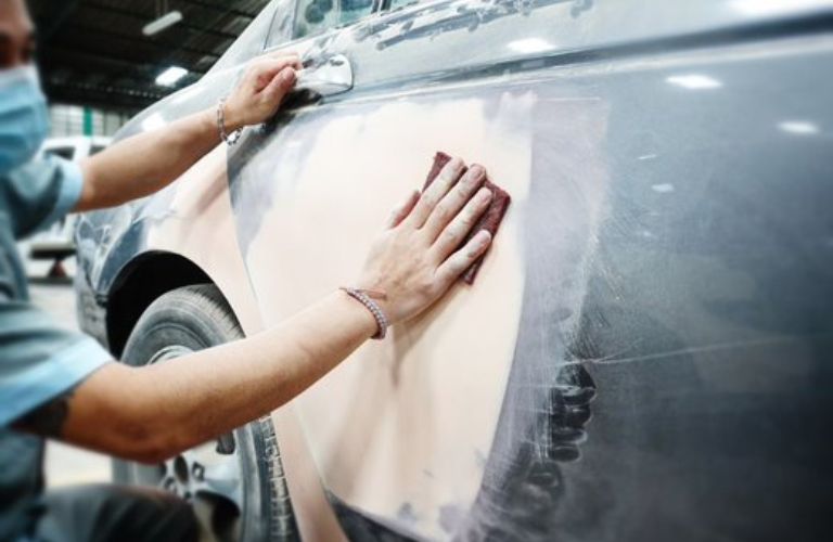 Mechanic working on the vehicle exterior