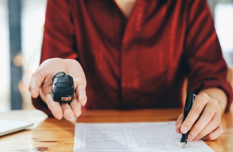 A woman holding a car key