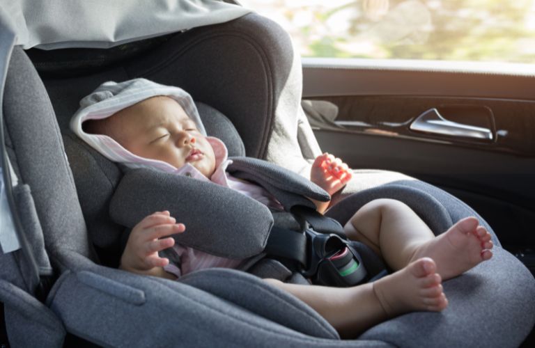 Toddler sleeping in a car seat