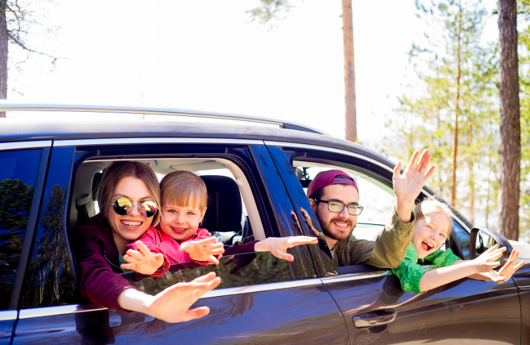 Family waving from a vehicle 