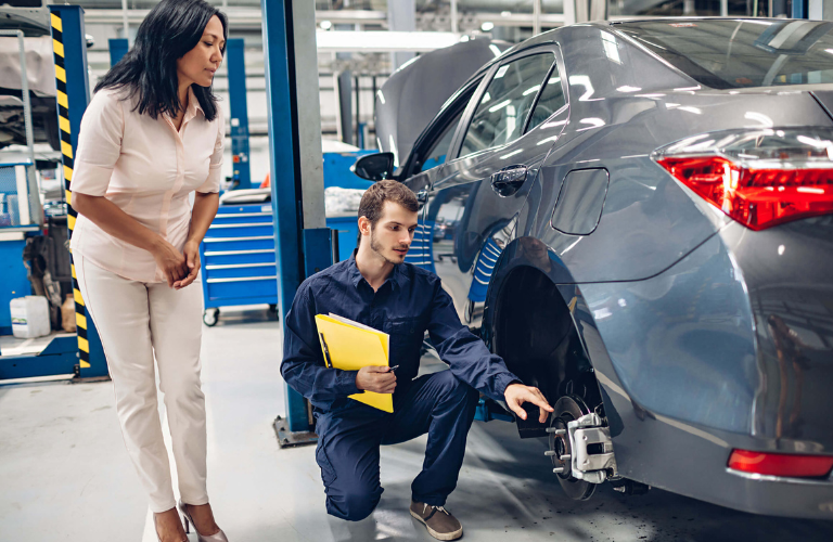 Mechanic with a customer at a service station 