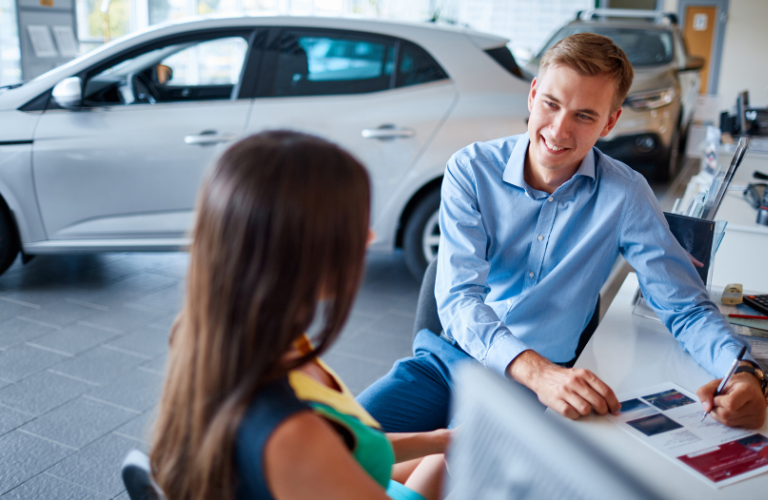 Salesperson and customer at a dealership