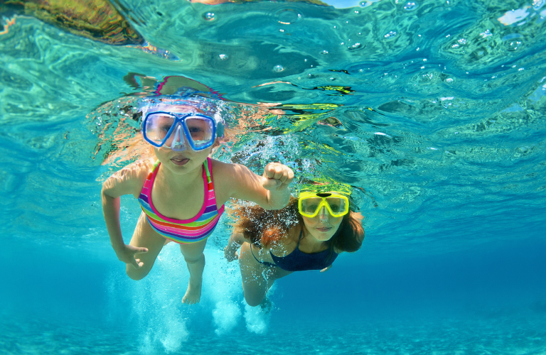 A mother and daughter swimming in the pool