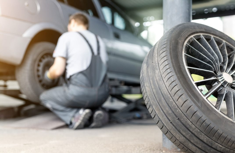 Technician working on a vehicle's tire